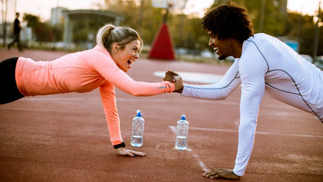 personal trainer helping clients<br>